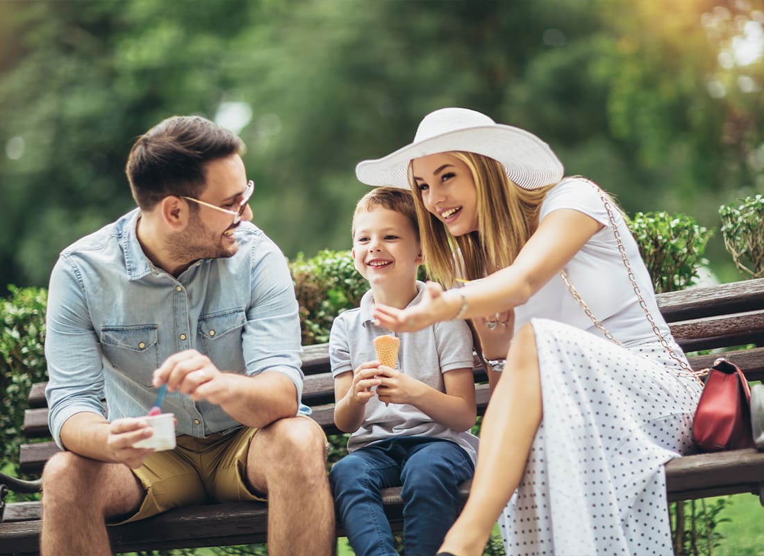 Personal Insurance - Young Happy Family Spending Their Weekend in the Park Eating Ice Cream